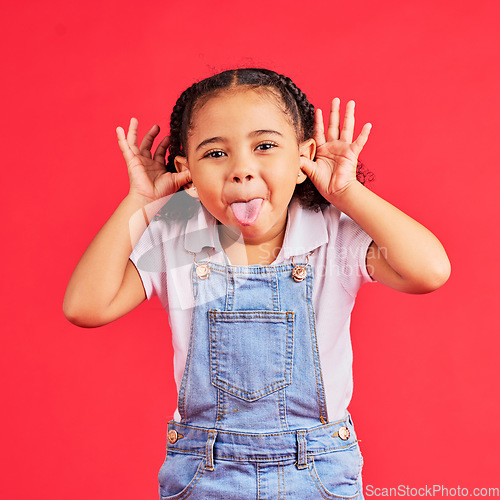 Image of Child, portrait and tongue out on isolated red background in goofy, silly games and playful facial expression. Happy, kid and little girl with funny face in comic emoji, charades and studio activity