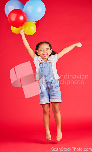 Image of Little girl, portrait or jumping with balloons on isolated red background for birthday party, celebration or fun event. Smile, happy or energy child with air, flying or inflatable accessory in studio
