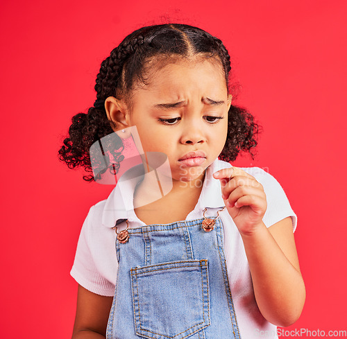 Image of Child, sad and finger injury with plaster on isolated red background for cut, sore and insect bite. Upset, unhappy and hurt little girl with bandage for medical help, healthcare wellness or first aid