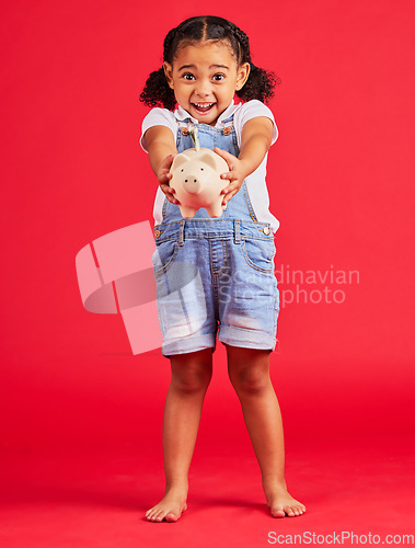 Image of Excited kid, portrait or piggy bank success in money planning, savings or future investment on isolated red background. Smile, happy child or cash box in finance growth, budget learning or investment