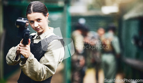 Image of Paintball portrait, woman and gun aim in gaming arena, leadership or sports teamwork in military uniform. Player, shooter and playing rifle for soldier, person or army war training in games challenge