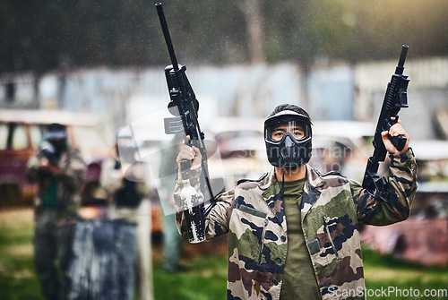Image of Paintball, gun or man ready for a shooting game with fast action on a fun battlefield on holiday. Mission, man or player with military weapons gear for survival in an outdoor competition playground