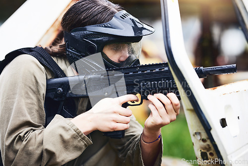 Image of Paintball, gun or woman in a shooting game playing with fast action on fun battlefield on holiday. Military mission, target aim or player with weapons gear for war survival in an outdoor competition