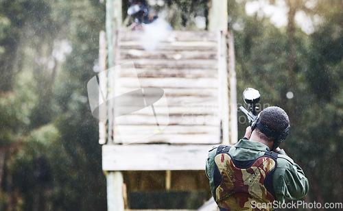 Image of Paintball, gun or man with a target in shooting game with fast action on a fun battlefield on holiday. Military mission, aiming or player with weapons gear for war survival in an outdoor competition