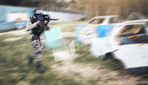 Image of Paintball, gun or man running in a shooting game with fast action on a fun battlefield on holiday. Military mission, fitness or player with speed, weapons gear for survival in an outdoor competition