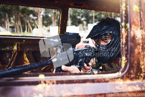 Image of Paintball, aim or man with a gun in shooting game with action on a fun battlefield on holiday. War mission, focused or calm player with military weapons gear for survival in an outdoor competition