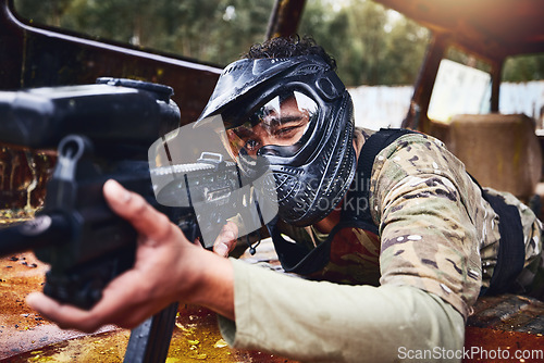 Image of Paintball, gun or soldier in a shooting game with fast action on a fun battlefield on holiday. Military mission, target or focused man with war weapons gear for survival in an outdoor competition