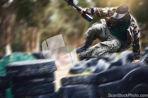 Image of Fast, moving and man playing paintball with action, military clothes and running during a game in Australia. War, sport and person with blurred motion during a fun, playful and outdoor competition