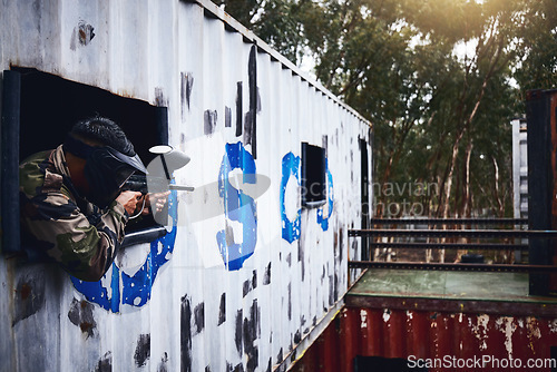 Image of Paintball, gun or player in a shooting game with war action on a fun battlefield on holiday vacation. Military mission, fitness or man aiming with weapons gear for survival in an outdoor competition