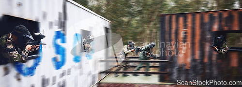 Image of Paintball, gun or people running in a shooting game with fast action on a fun battlefield on holiday. Men on mission, war or players with military weapons gear for survival in an outdoor competition