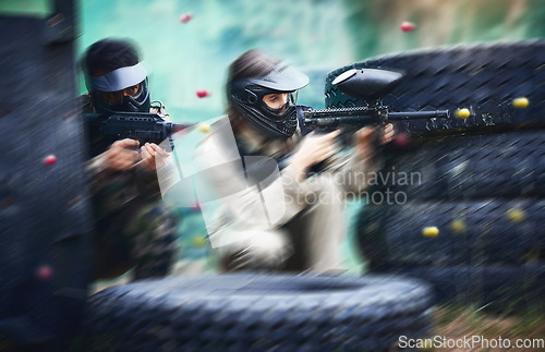 Image of Paintball, gun or people in a shooting action game with fast action on a fun battlefield on holiday. Men on mission, war or players with military weapons gear for survival in an outdoor competition