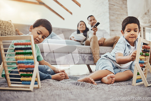 Image of Math, family or children learning for development growth with mother and father relaxing watching tv. Education, siblings or young boys playing fun toys or counting games for kids at home together