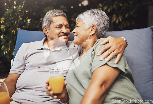 Image of Senior couple, hug and juice on a garden patio sofa with love and care for marriage and retirement. Conversation, morning talking and relax discussion of elderly man and woman outdoor with happiness