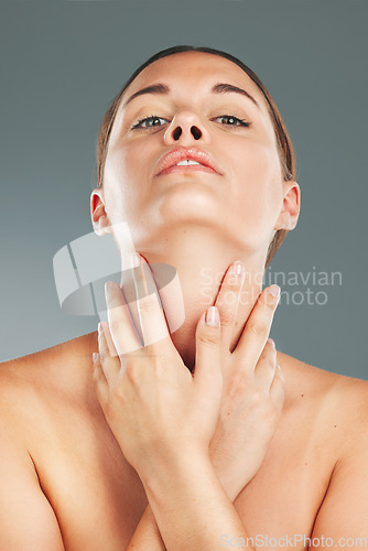 Image of Woman, beauty and skincare holding neck in satisfaction for cosmetic treatment against grey studio background. Portrait of beautiful female touching soft, smooth or perfect skin for healthy wellness