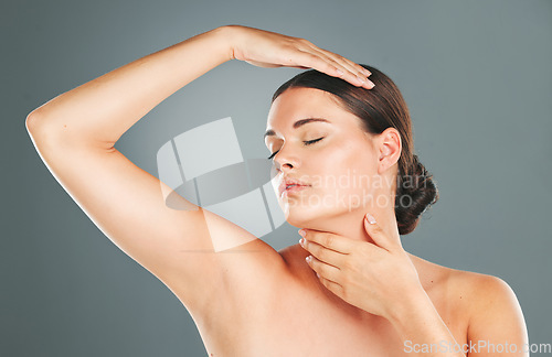 Image of Facial, skincare and woman for beauty aesthetic on gray background for cosmetics, luxury treatment and spa. Dermatology, wellness and face of girl pose with hands for glowing, healthy and smooth skin