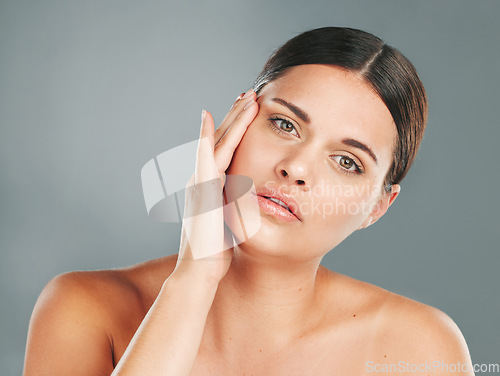 Image of Beauty, portrait and woman touching face in studio for skincare, wellness and facial cosmetics. Young female model, aesthetic makeup and dermatology from healthy shine, natural glow and salon results