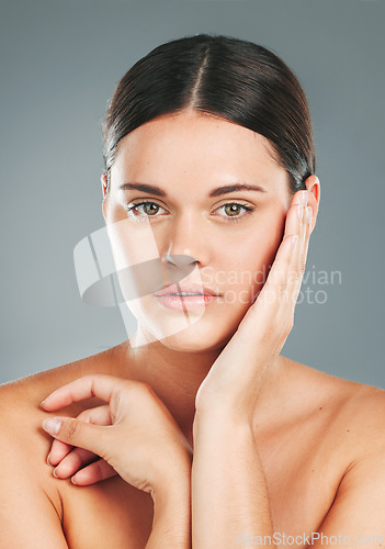 Image of Beauty, portrait and woman hands touching face in studio for wellness, luxury facial and cosmetics. Young female model, aesthetic skincare and dermatology from healthy shine, glow and salon results