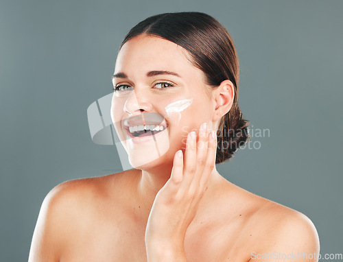 Image of Skincare cream, beauty portrait and woman face with happiness from sunscreen and self care. Wellness, spa and smile of model with collagen lotion with studio background and dermatology treatment