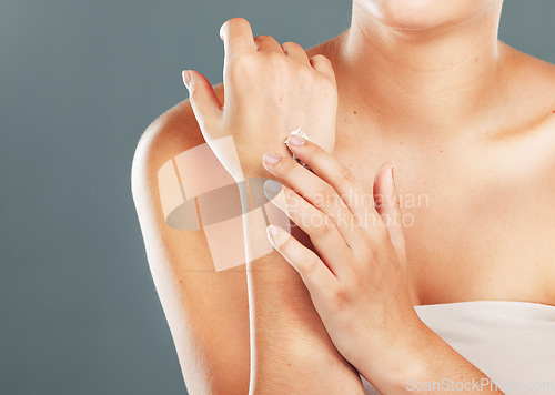 Image of Hands, beauty cream and skincare of a woman with moisturizer on arms and hand in studio. Isolated, gray background and person with cosmetic, dermatology and spa lotion for skin with mockup