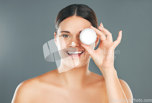 Image of Woman apply cream for face with happiness and beauty portrait, skincare and moisturizer isolated on studio background. Sunscreen, lotion and healthy skin glow, wellness and facial treatment product