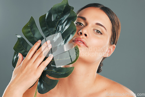 Image of Leaf, face and woman in portrait, beauty and hand with manicure and natural cosmetics isolated on studio background. Eco friendly cosmetic care, facial and skincare with dermatology and wellness