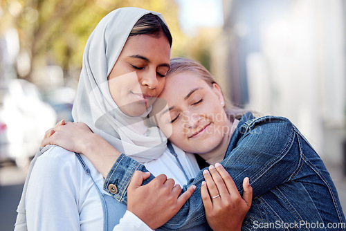 Image of Friends, women and hug outdoor, peace and reunion in street together, happiness and calm. Females with trust, ladies or embrace in city, achievement and wellness with quality time, summer and freedom