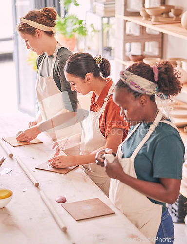 Image of Pottery art and creative people row in workshop sculpting together for production process and productivity. Focus, concentration and skill of interracial team of women busy at workspace.