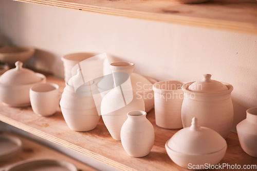 Image of Pottery background, creativity and shelf in studio, creative store or manufacturing startup. Clay design, collection and display in workshop, small business and retail craft shop of stock production