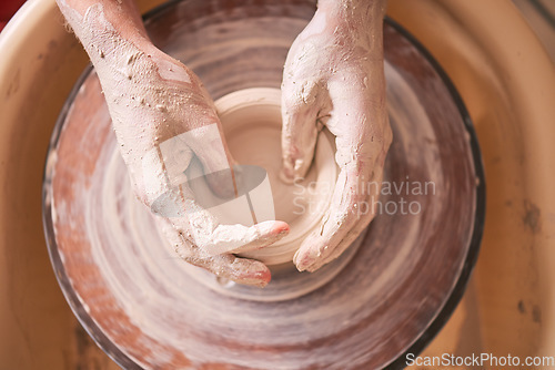 Image of Creative, pottery and design with hands of woman in workshop studio for molding, ceramics and art. Clay, sculpture and manufacturing with girl artisan on wheel for crafting, handmade and hobby