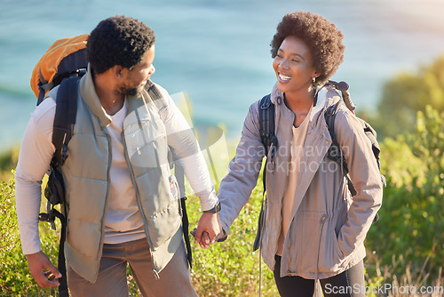 Image of Black couple, happy and holding hands on hike journey for outdoor exploration, sightseeing and togetherness. Happiness, love and care of people trekking with backpack and smile for travel freedom.