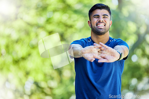 Image of Fitness, mock up and stretching arms with a man outdoor in nature for a warm up before exercise. Workout, mockup and training with a male athlete on a natural green background for health or cardio