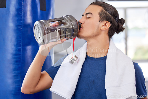 Image of Fitness, man and drinking water in gym for health, rest and energy for boxing, workout and towel. Thirsty sports person, bodybuilder and athlete hydration, bottle and exercise nutrition for wellness