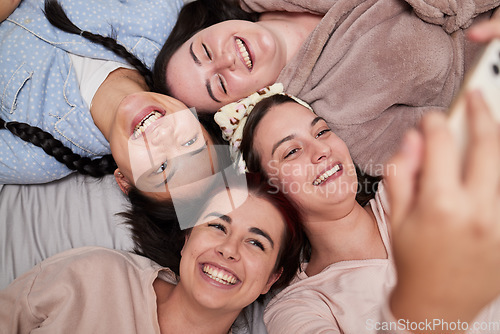 Image of Selfie, happy and friends lying in a circle while at a fun friendship sleepover at a house. Happiness, smile and women taking a picture for memories while relaxing, laughing and bonding together.