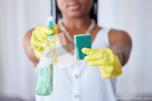 Image of Hands, spray bottle and sponge with a black woman cleaner in a home for housework, hygiene or cleaning. Gloves, spraying and equipment with a female maid in a house for domestic housekeeping