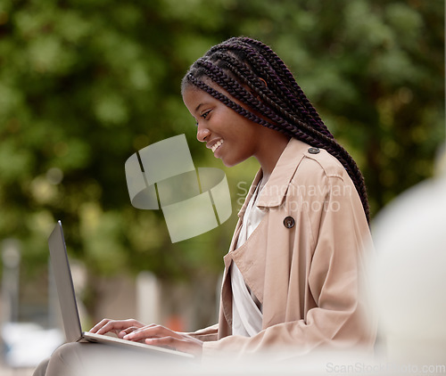 Image of Business, city and black woman typing on laptop in street, social media or internet browsing. Remote worker, computer and happy female employee working on research, email or project in town outdoors.