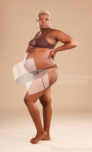 Image of Pregnant, body and black woman isolated on studio background for beauty, skincare and abdomen health. Underwear, stomach and african model or person with pregnancy for wellness, care and self love