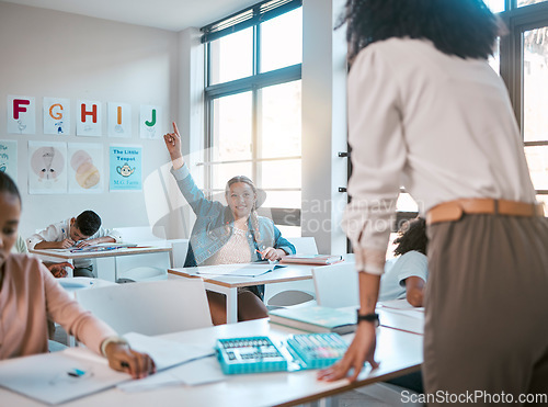 Image of Question, school and education with a student girl hand raised sitting in a classroom to ask or answer her teacher. Kids, asking and learning with a young female child in class to study for growth