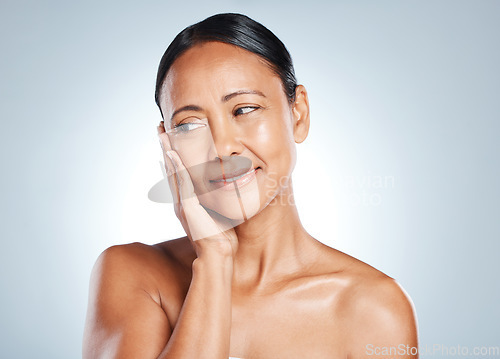 Image of Face, skincare and thinking with a model black woman in studio on a gray background for antiaging beauty. Skin, idea and facial with an attractive mature female touching her cheek for wellness