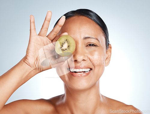 Image of Beauty, kiwi product and portrait of woman with smile on face for vitamin c facial detox and happy on studio background. Healthy skincare, wellness and sustainability in fruit, luxurycleaning on ey