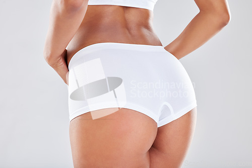 Image of Woman, ass and underwear with sexy waist in weight loss, diet or healthcare against a grey studio background. Isolated female model in white lingerie showing butt for healthy skincare, slim or size