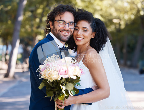 Image of Wedding portrait and flowers of couple with hug at romantic outdoor marriage event celebration together. Partnership, commitment and trust embrace of interracial bride and groom with excited smile.