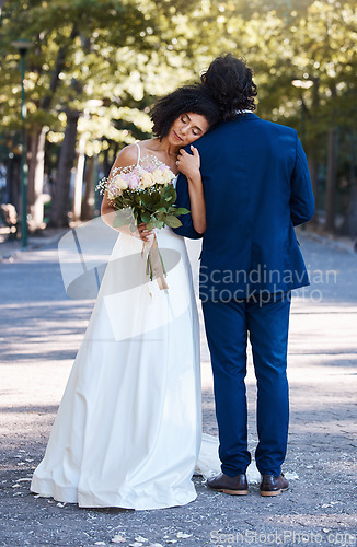 Image of Wedding, outdoor and couple marriage celebration event for bride and groom together with commitment. Married man and woman at ceremony with trust, partnership and support with flower bouquet and hug