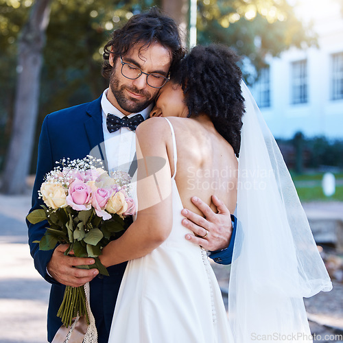 Image of Wedding, love and couple hug outdoor for marriage celebration event for bride and groom together. Married interracial man and woman at commitment ceremony for partnership and care with flower bouquet