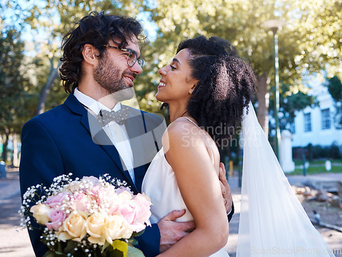 Image of Interracial love and couple wedding with flowers for romantic outdoor marriage event celebration together. Partnership, commitment and trust embrace of happy bride and groom with excited smile.