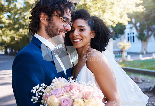 Image of Wedding, couple portrait and happy at marriage celebration event for people together for commitment. Interracial man and woman at ceremony with trust, partnership and a hug with flower bouquet