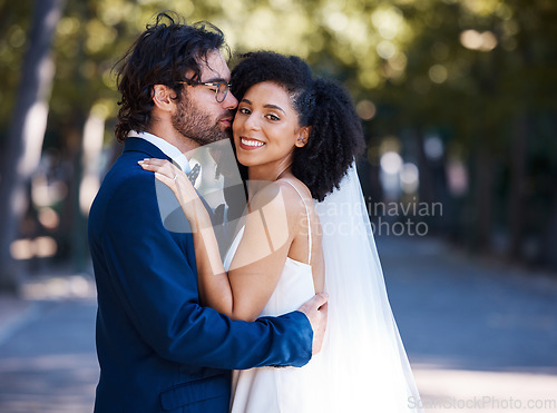 Image of Interracial wedding and couple kiss portrait at romantic outdoor marriage event celebration together. Partnership, commitment and trust embrace of happy bride and groom with excited smile.