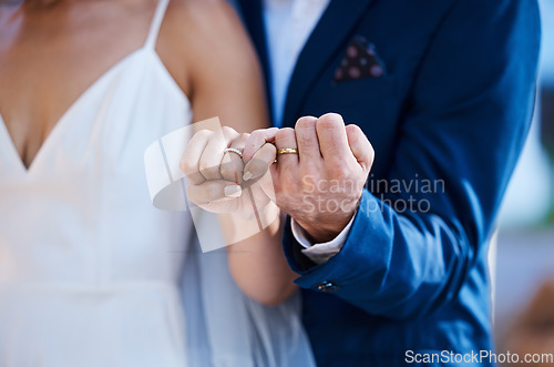 Image of Hands, pinky promise and wedding ring of couple outdoor celebration of trust, partnership and love. Marriage commitment or loyalty of interracial bride and groom at ceremony to celebrate togetherness