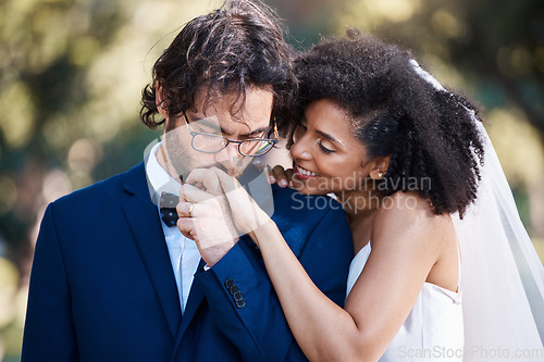 Image of Wedding, kiss on hand and happy couple outdoor for marriage celebration event together with commitment. Interracial man and woman at ceremony with trust, partnership and respect with smile from bride