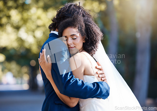 Image of Care, hug and wedding bride with groom at romantic outdoor marriage event celebration together. Partnership, commitment and trust embrace of married interracial couple in nature with bokeh.