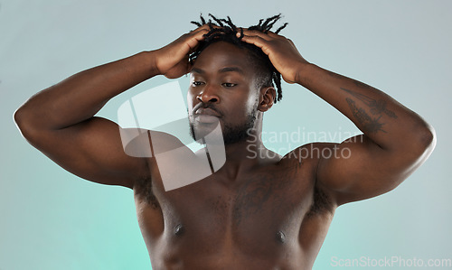 Image of Black man, hair and muscle with skin, face and beauty, skincare and fitness with body isolated on studio background. Health, wellness and grooming, strong bodybuilder and power with hygiene and clean